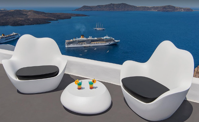 Athina Luxury Suites infinity pool overlooking Santorini caldera at sunset Greece
