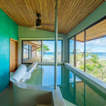 Hotel Boutique Lagarta Lodge infinity pool Pacific Ocean jungle canopy view Nosara Costa Rica